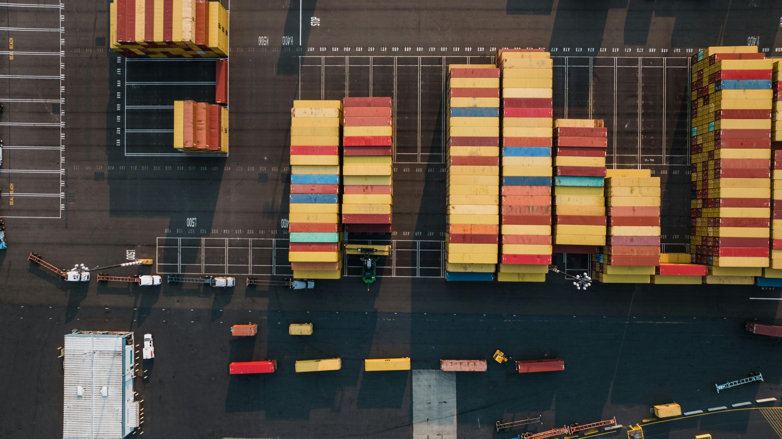 High-angle view of colorful cargo containers at a Seattle port, showcasing logistics and freight movement.