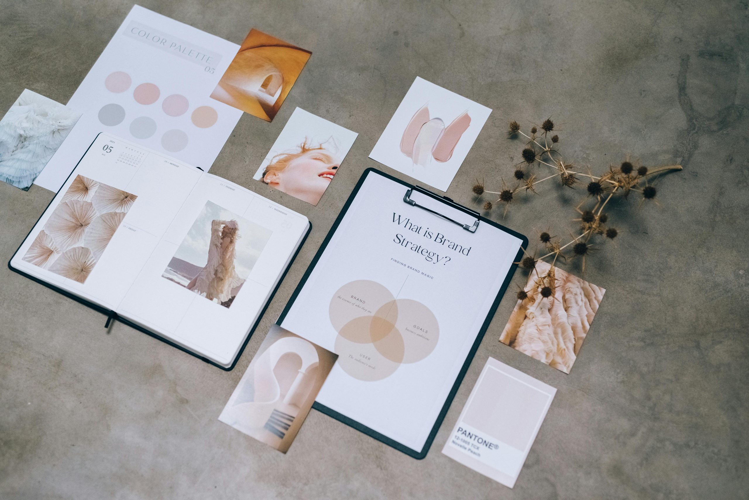 Flat lay of branding strategy materials with moodboard and color palette for creative design.